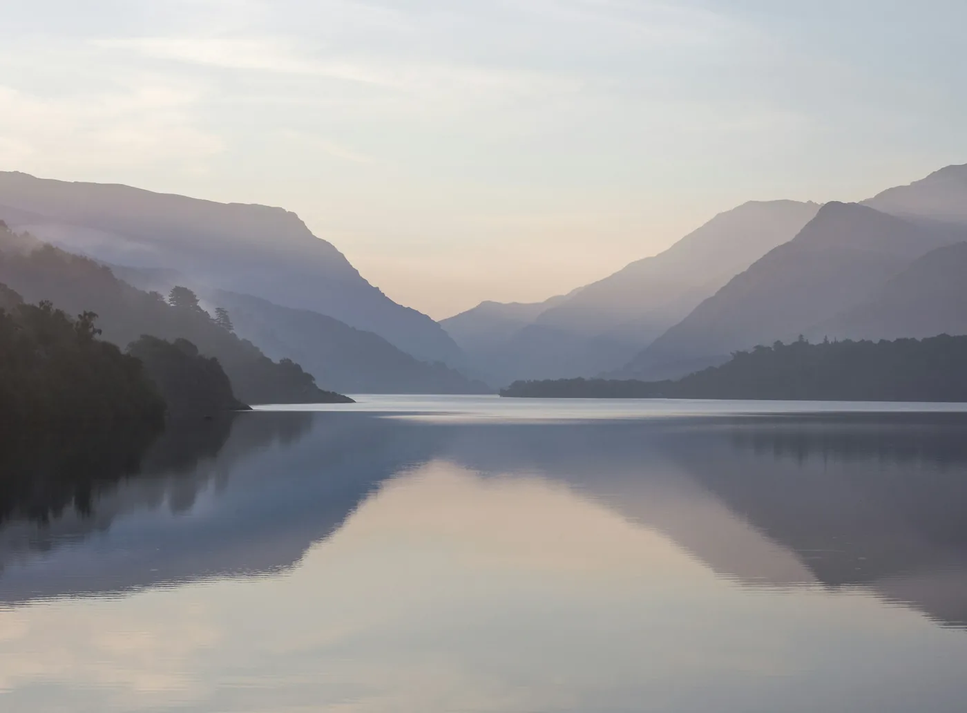 Still mountain lake in soft morning light
