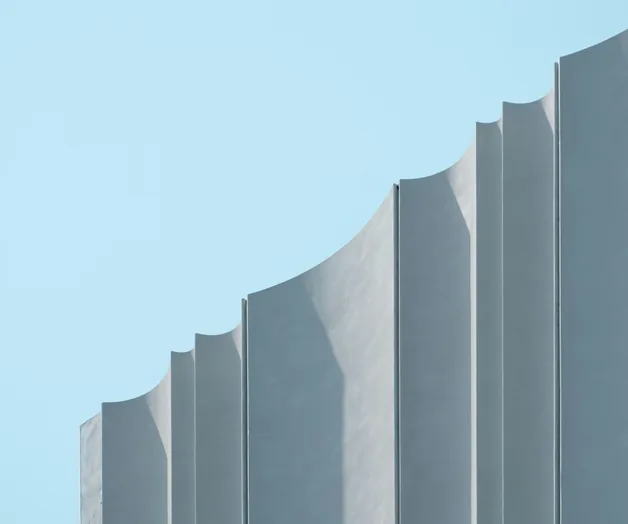 Pale concrete building against a blue sky