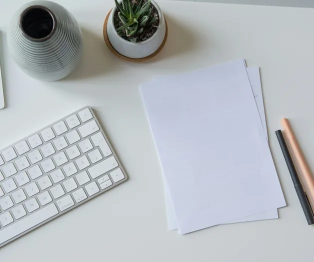 Paper and keyboard on a white desk