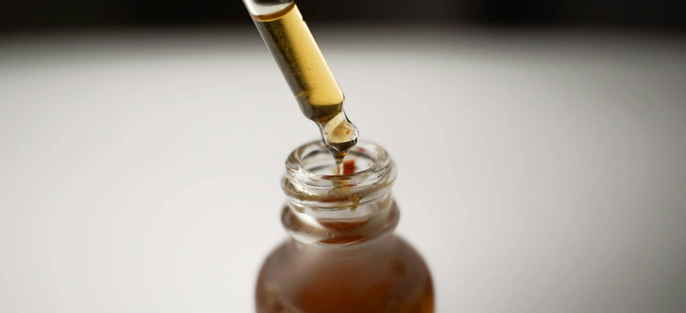 Pipette drawing serum from an amber bottle